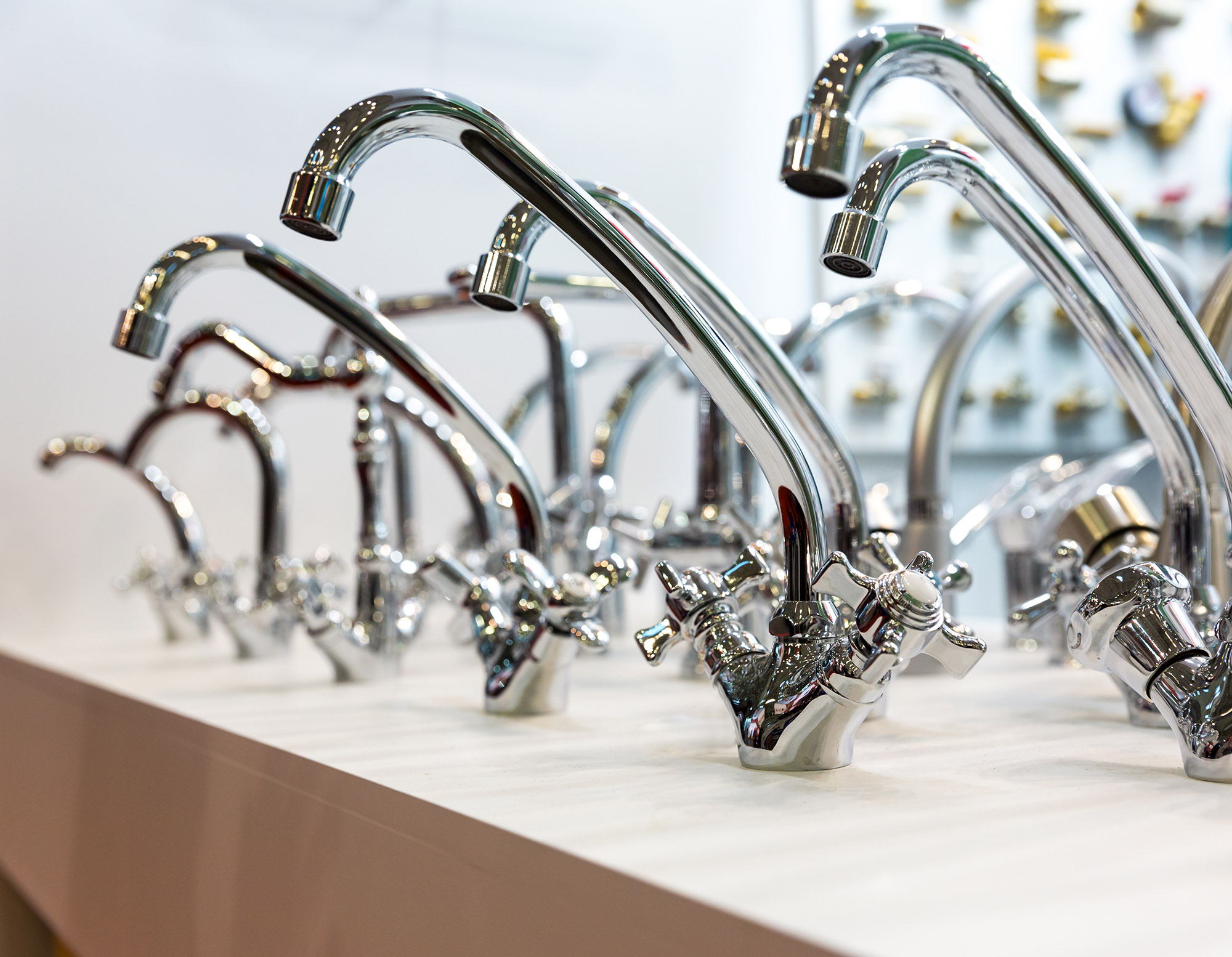 New kitchen water faucets on the shelf at plumbing shop